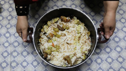 A Palestinian woman prepares maqlouba at her home in the East Jerusalem neighborhood of Jabel Mukaber